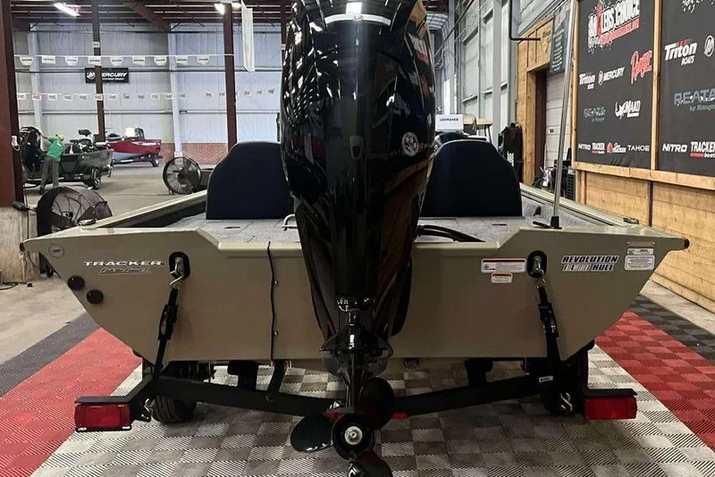 Slide: The Image of 2026 Tracker Pro Team 175 boat in showroom, rear view with motor. - 3