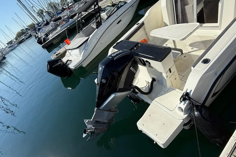 Slide: The Image of 2024 Bayliner Trophy T25 Pilothouse docked with Mercury outboard engine. - 10