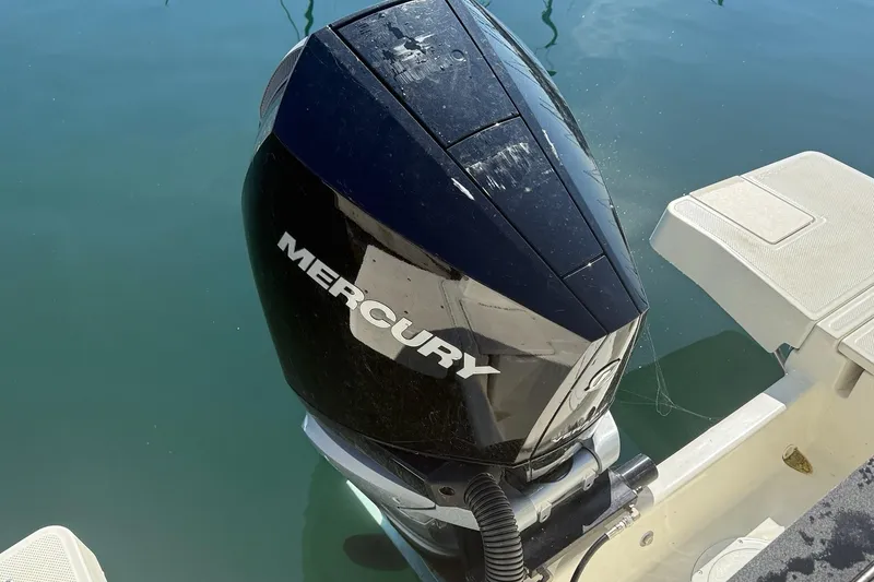 Slide: The Image of 2024 Bayliner Trophy T25 Pilothouse with Mercury outboard engine on calm water. - 15