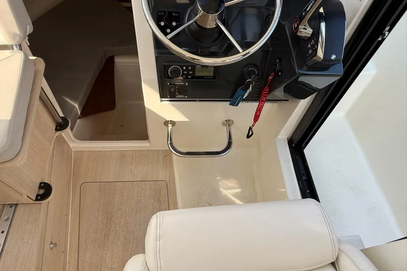 Slide: The Image of 2024 Bayliner Trophy T25 Pilothouse helm with steering wheel and control panel. - 37