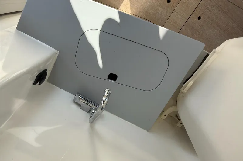 Slide: The Image of 2024 Bayliner Trophy T25 Pilothouse interior detail with faucet and storage compartment. - 46