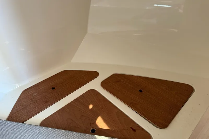 Slide: The Image of 2024 Bayliner Trophy T25 Pilothouse interior with wooden floor panels. - 57