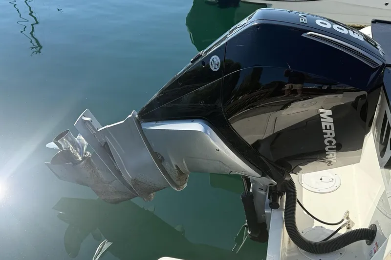 Slide: The Image of 2024 Bayliner Trophy T25 Pilothouse with Mercury outboard engine in water. - 9