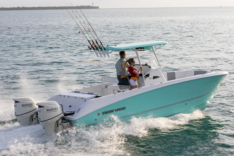 Slide: The Image of Manufacturer Provided Image: 2024 Twin Vee 240 GFX CC boat cruising on water with fishing rods. - 1
