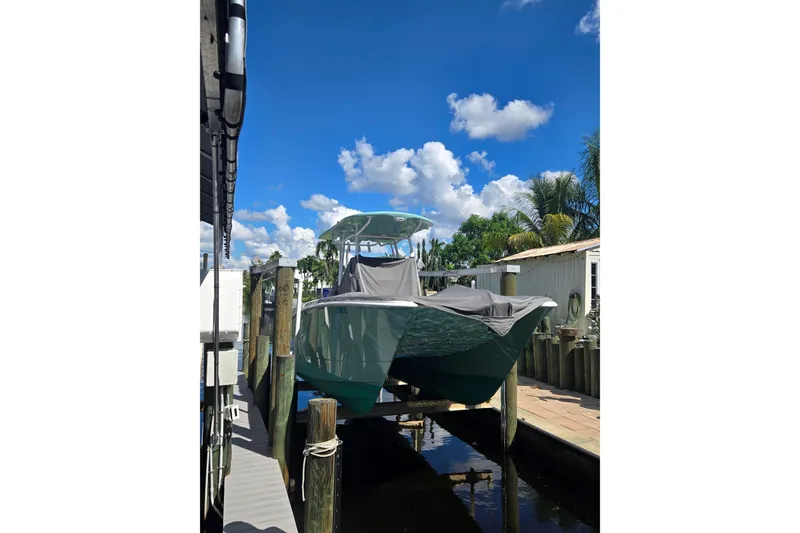 Slide: The Image of 2024 Twin Vee 240 GFX CC boat docked under a clear blue sky. - 14