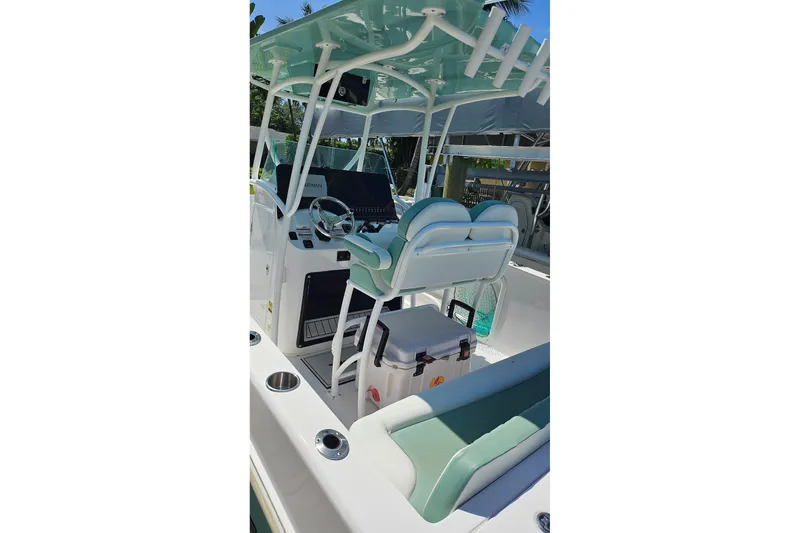Slide: The Image of 2024 Twin Vee 240 GFX CC boat interior with helm, seating, and equipment. - 15