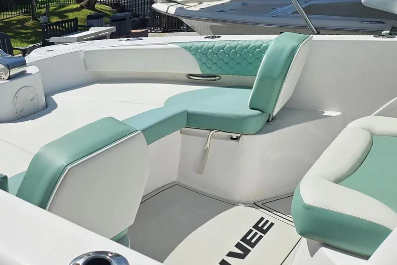 Slide: The Image of 2024 Twin Vee 240 GFX CC boat interior with teal and white seating. - 6