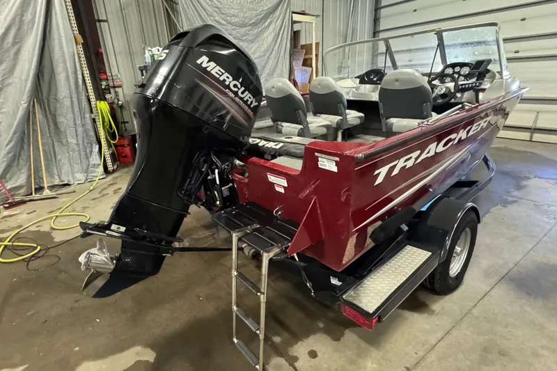Slide: The Image of 2014 Tracker Pro Guide V-175 Combo boat with Mercury outboard motor in a garage. - 3