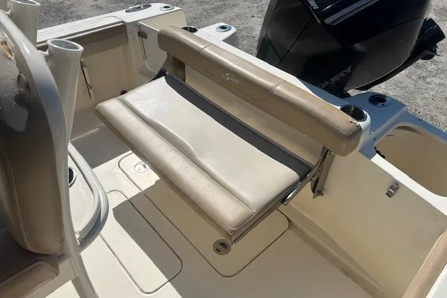 Slide: The Image of 2022 Scout 215 XSF boat with foldable rear seat and outboard motor. - 13