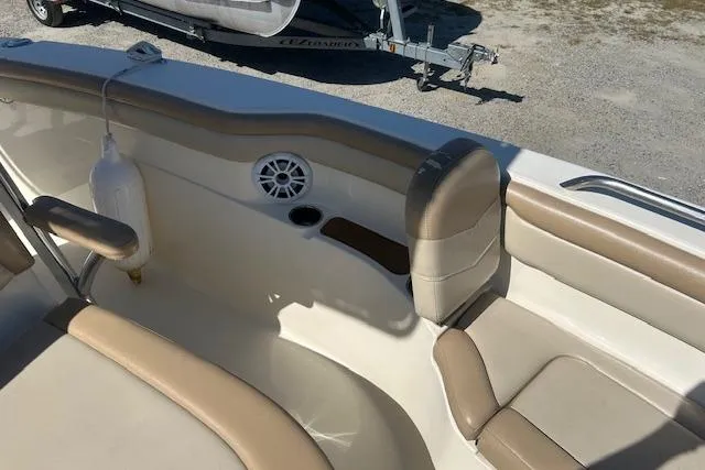 Slide: The Image of 2022 Scout 215 XSF boat interior with beige seating and speaker detail. - 18