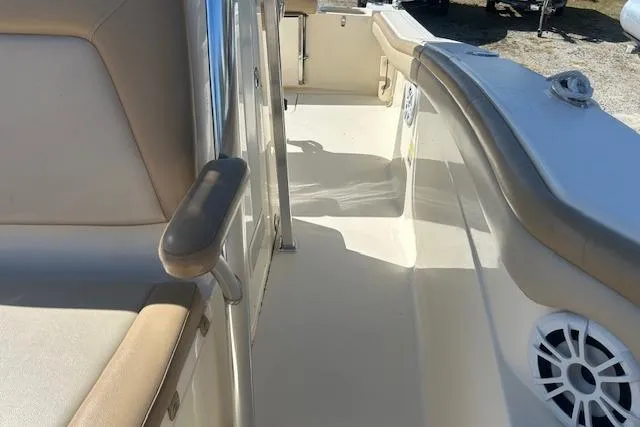 Slide: The Image of 2022 Scout 215 XSF boat interior with beige seating and speaker. - 19