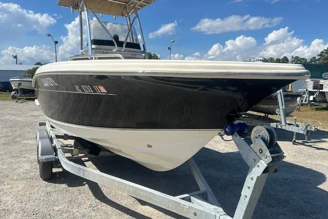 Slide: The Image of 2022 Scout 215 XSF boat on trailer under blue sky. - 2