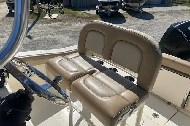 Slide: The Image of 2022 Scout 215 XSF boat interior with beige seating and steering wheel. - 22
