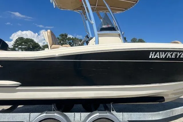 Slide: The Image of 2022 Scout 215 XSF boat on trailer under clear blue sky. - 4