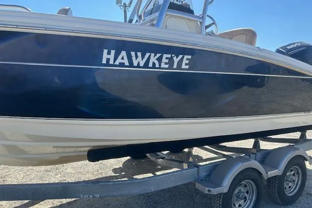 Slide: The Image of 2022 Scout 215 XSF boat named "Hawkeye" on a trailer, side view. - 8