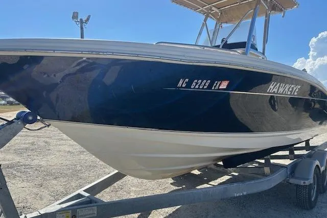 Slide: The Image of 2022 Scout 215 XSF boat on trailer, side view with registration number visible. - 9