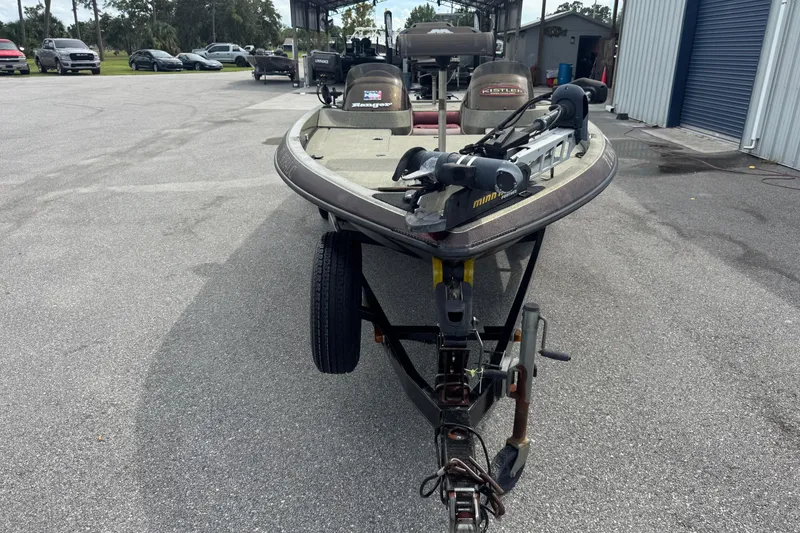 Slide: The Image of 2000 Ranger 520DVX Comanche boat on trailer in parking lot. - 2