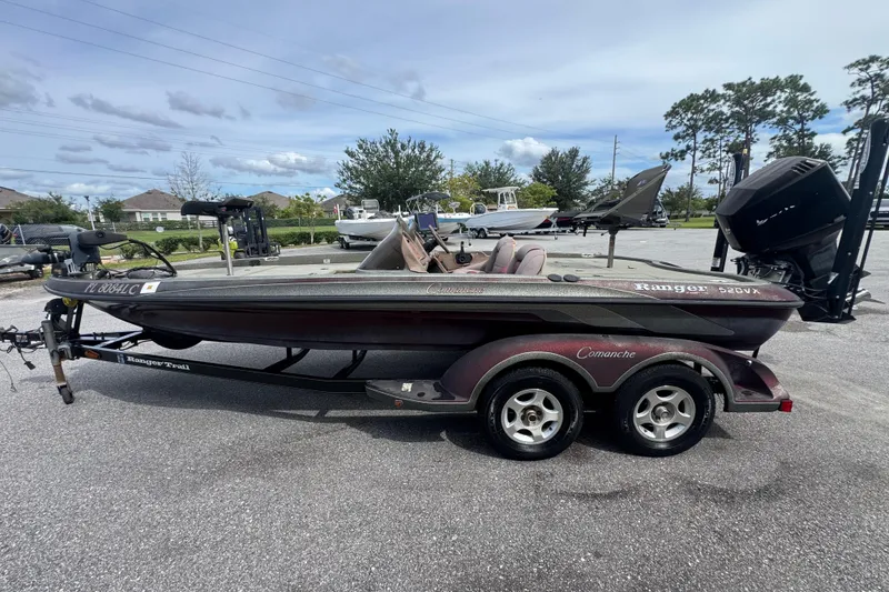 Slide: The Image of 2000 Ranger 520DVX Comanche boat on trailer in parking lot. - 4