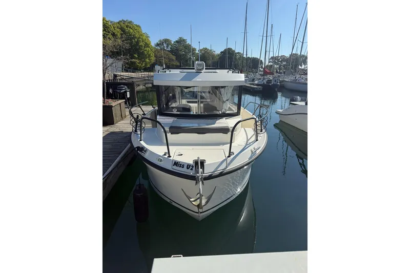 Slide: The Image of 2024 Bayliner Trophy T25 Pilothouse boat docked in a marina. - 1