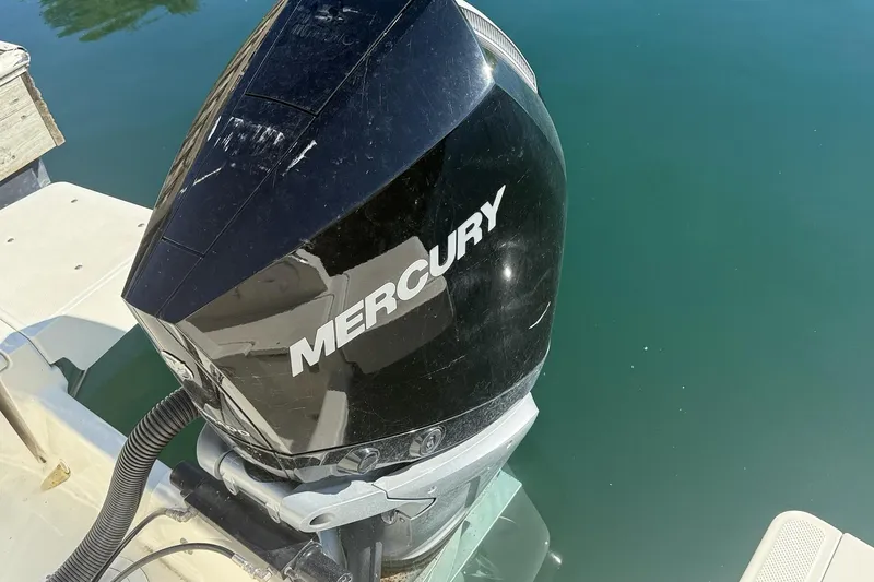 Slide: The Image of Mercury outboard motor on 2024 Bayliner Trophy T25 Pilothouse, docked on calm water. - 17