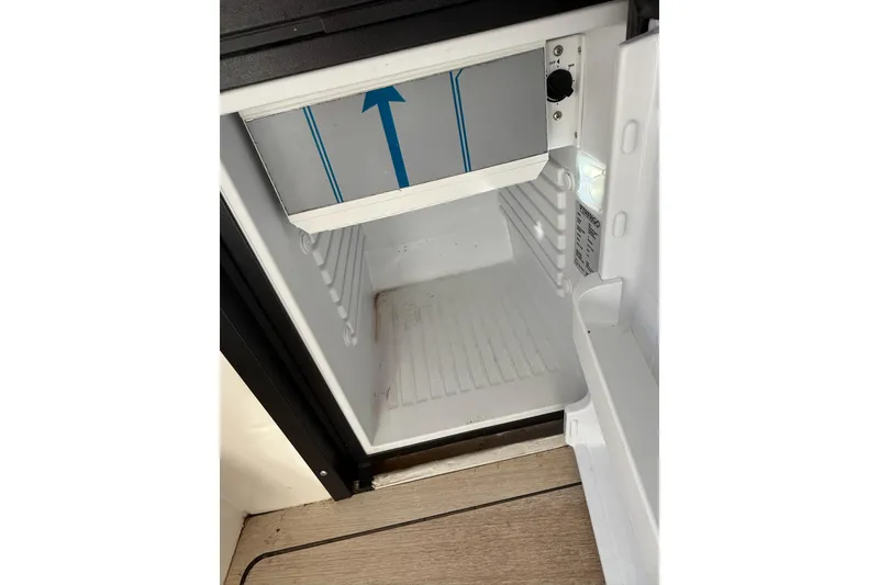 Slide: The Image of Open refrigerator inside 2024 Bayliner Trophy T25 Pilothouse boat. - 44