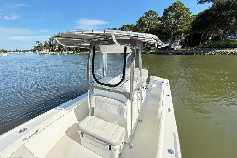 Slide: The Image of 2020 Parker 2100 Special Edition boat on calm water, surrounded by trees. - 17