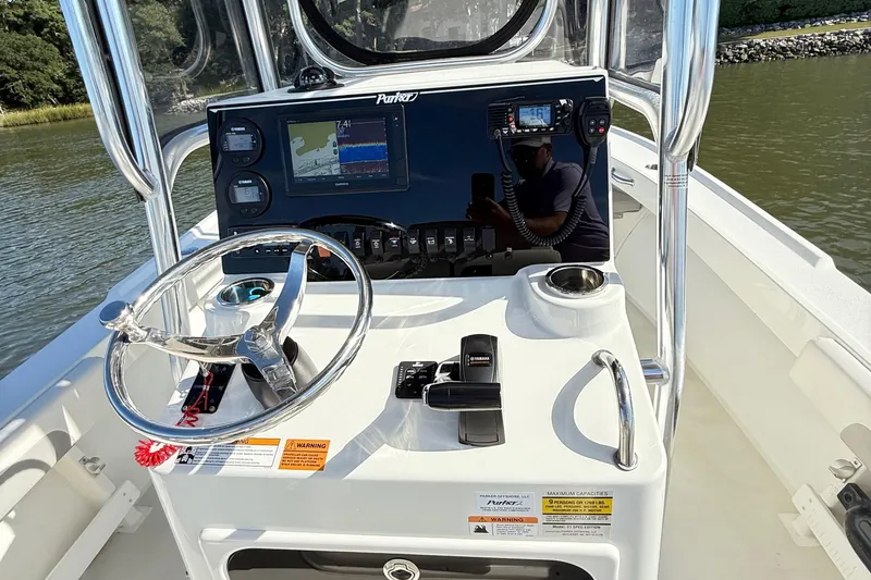 Slide: The Image of Control panel of a 2020 Parker 2100 Special Edition boat with steering wheel and navigation display. - 21