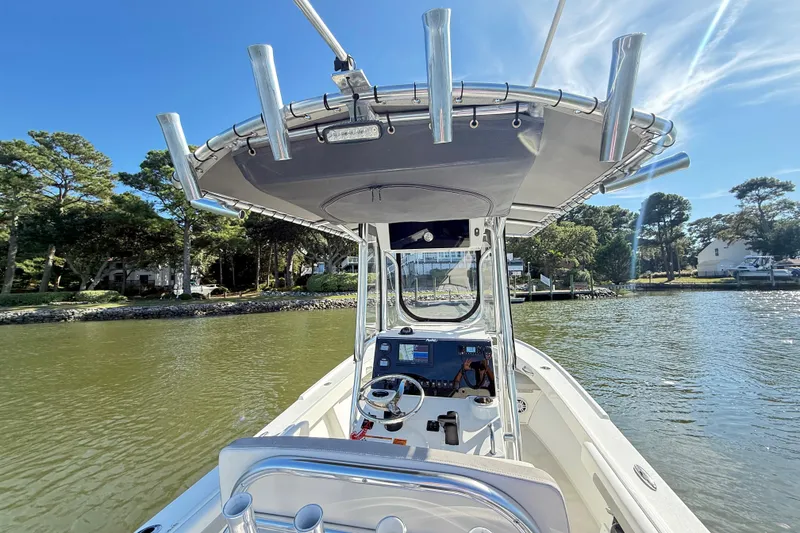 Slide: The Image of 2020 Parker 2100 Special Edition boat on calm water, surrounded by trees and houses. - 22