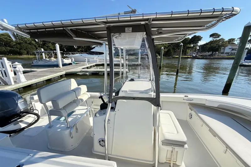 Slide: The Image of 2020 Parker 2100 Special Edition boat docked at marina, featuring sleek design and seating. - 24