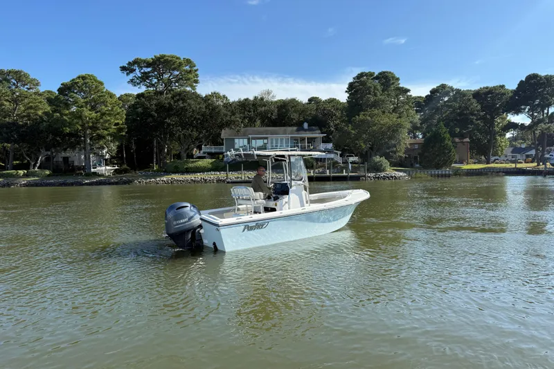 Slide: The Image of 2020 Parker 2100 Special Edition boat interior with seating and console on a sunny day. - 40
