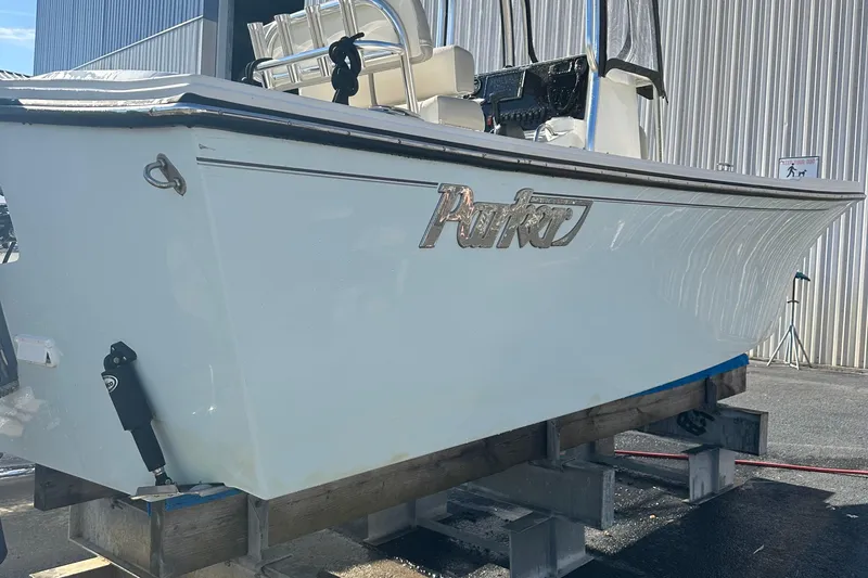 Slide: The Image of 2020 Parker 2100 Special Edition boat on display, side view, in a marina setting. - 8