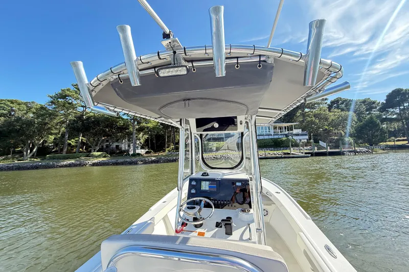 Slide: The Image of 2020 Parker 2100 Special Edition boat on calm water, featuring a modern helm and canopy. - 9