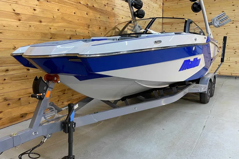 Slide: The Image of 2024 Malibu Wakesetter 23 MXZ boat on trailer in wooden garage. - 3