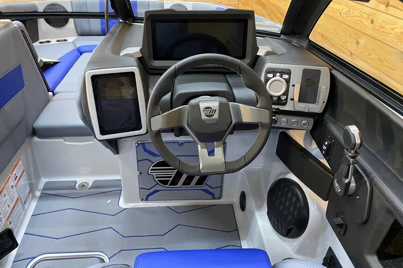 Slide: The Image of 2024 Malibu Wakesetter 23 MXZ dashboard with modern steering and digital controls. - 5