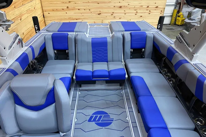 Slide: The Image of 2024 Malibu Wakesetter 23 MXZ interior with blue and gray seating, showcasing luxury and comfort. - 7