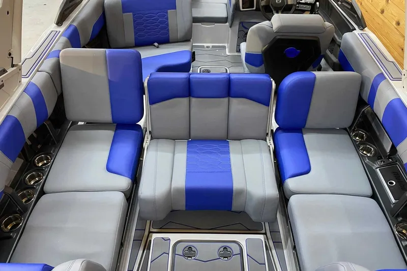 Slide: The Image of 2024 Malibu Wakesetter 23 MXZ interior with blue and gray seating, showcasing luxury and comfort. - 9