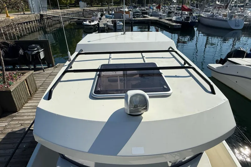 Slide: The Image of 2024 Bayliner Trophy T25 Pilothouse boat docked at marina, top view. - 21
