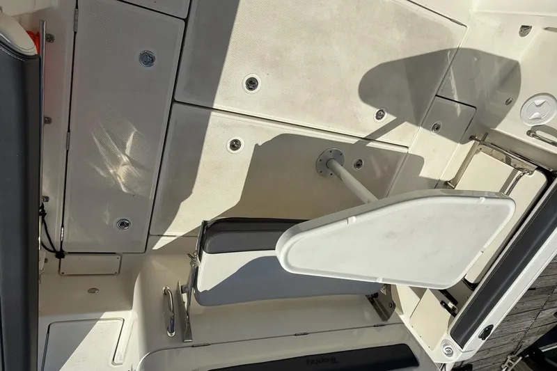 Slide: The Image of 2024 Bayliner Trophy T25 Pilothouse deck with seating and storage compartments. - 28