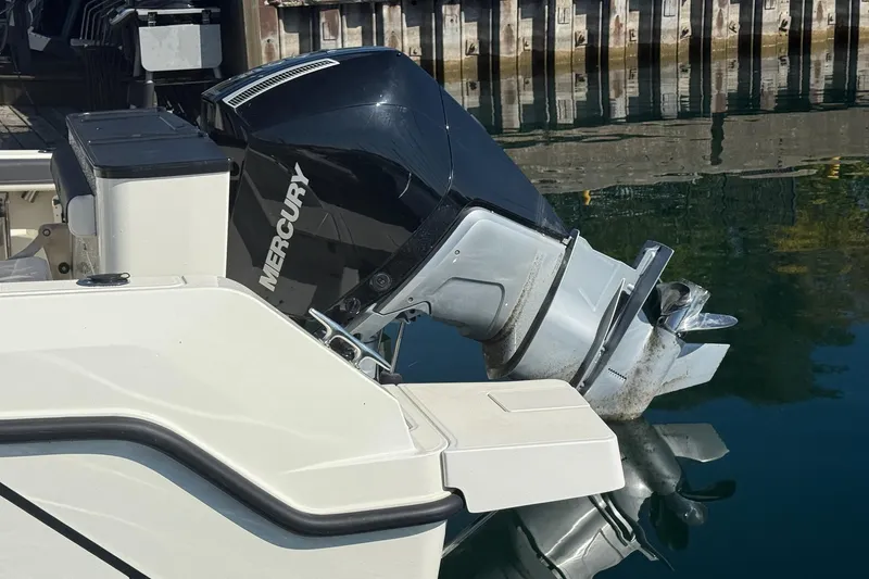 Slide: The Image of 2024 Bayliner Trophy T25 Pilothouse with Mercury outboard engine at dock. - 6