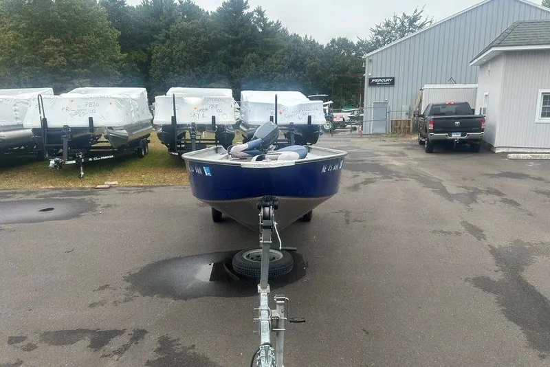 Slide: The Image of 2020 MirroCraft 3673 boat on trailer in a dealership lot, surrounded by other boats. - 11
