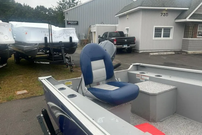 Slide: The Image of 2020 MirroCraft 3673 boat with blue seating, parked near dealership. - 12