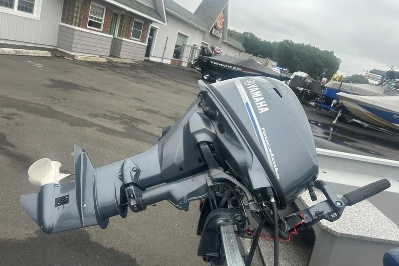 Slide: The Image of Yamaha outboard motor on a 2020 MirroCraft 3673 boat, parked near a dealership. - 6