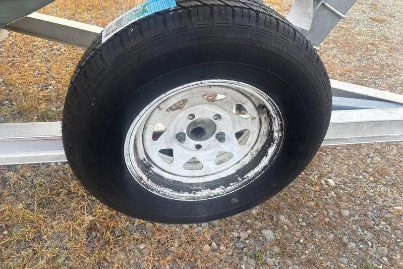 Slide: The Image of Trailer wheel for 2013 Key West 186 Center Console boat on gravel. - 8