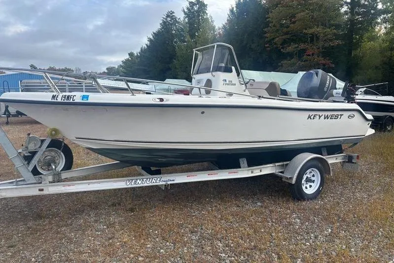 Slide: The Image of 2013 Key West 186 Center Console boat on trailer, parked outdoors. - 9
