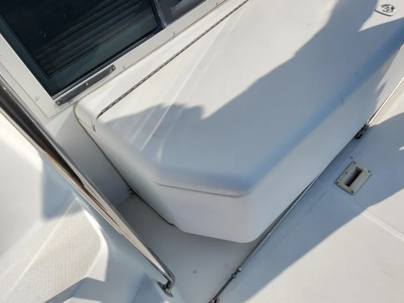 Slide: The Image of 2000 Carver 356 Aft Cabin Motor Yacht seating area with white upholstery and metal railing. - 13