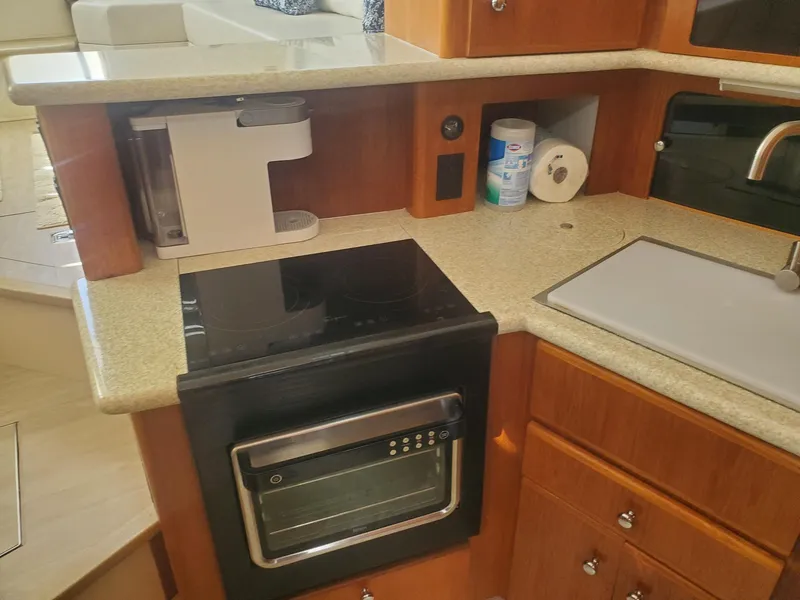 Slide: The Image of Kitchen area in 2000 Carver 356 Aft Cabin Motor Yacht with appliances and countertop. - 34