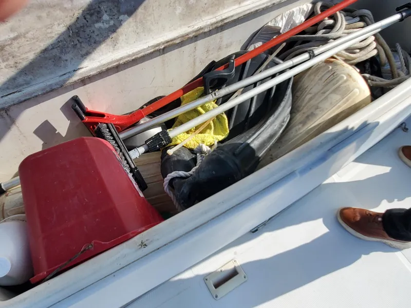 Slide: The Image of Storage compartment on a 2000 Carver 356 Aft Cabin Motor Yacht with cleaning tools and ropes. - 14