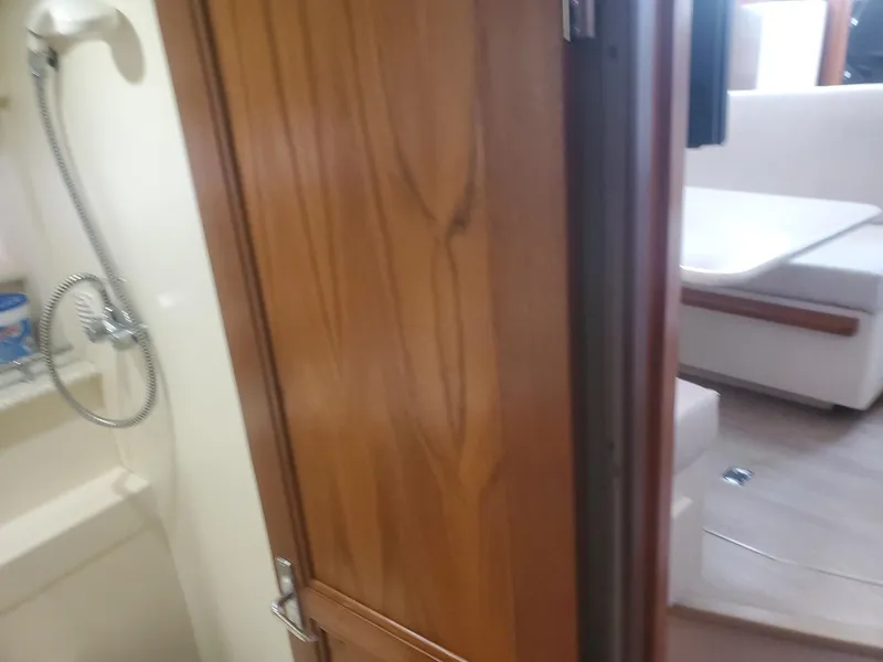 Slide: The Image of Interior view of 2000 Carver 356 Aft Cabin Motor Yacht, featuring wooden door and seating area. - 27