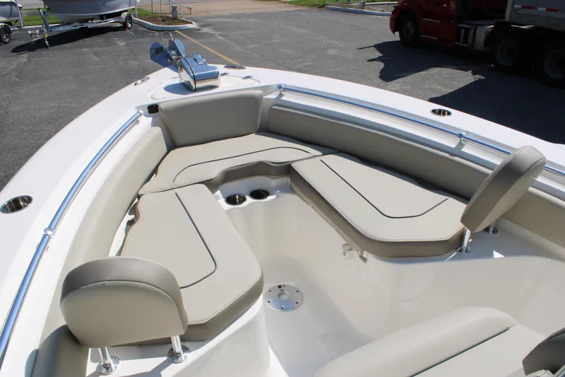Slide: The Image of 2024 Key West 219 FS boat interior with cushioned seating and cup holders. - 5
