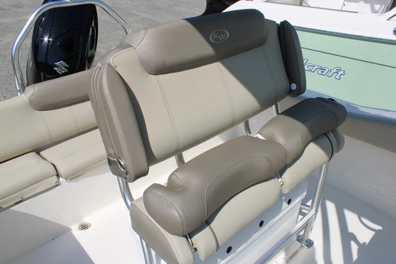 Slide: The Image of 2024 Key West 219 FS boat seating with beige upholstery and stainless steel frame. - 7